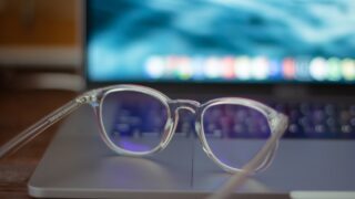 silver framed eyeglasses on white table